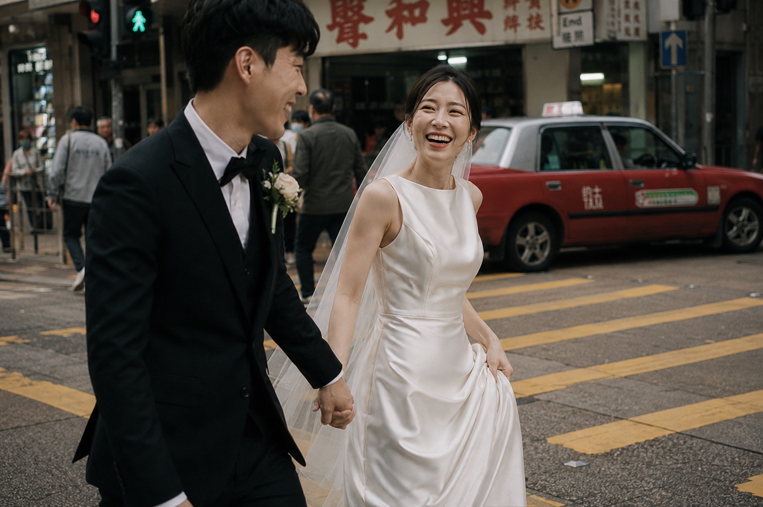 Suki laughing as she and Adrian walk past a red Hong Kong taxi